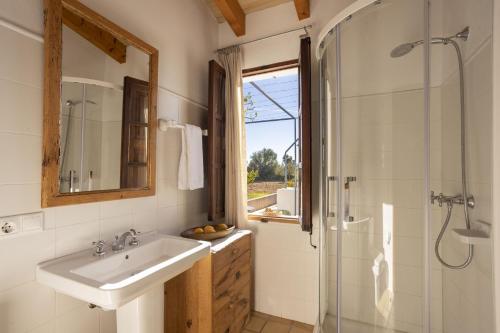 a bathroom with a sink and a shower at Finca Faustina Only Adults in Selva in El Port de la Selva