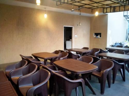 a room filled with wooden tables and chairs at HOTEL HOLY CITY in Amritsar