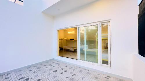 a room with white walls and a large window at 26 LaPorte in Pondicherry