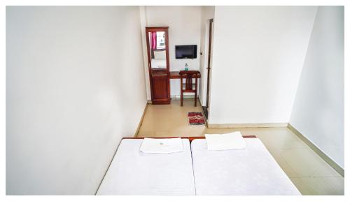 a room with two beds in a room with a door at Kay Kay Residency in Cochin