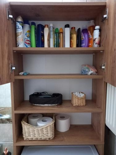 a cupboard filled with lots of bottles and toilets at PUZZLE SWEET HOME in Serres