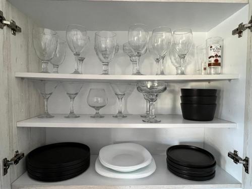 a bunch of wine glasses on shelves in a kitchen at La Ventana Apartments #6 in La Ventana