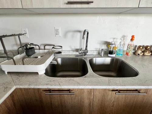 a kitchen sink with a dish drying rack next to it at La Ventana Apartments #6 in La Ventana