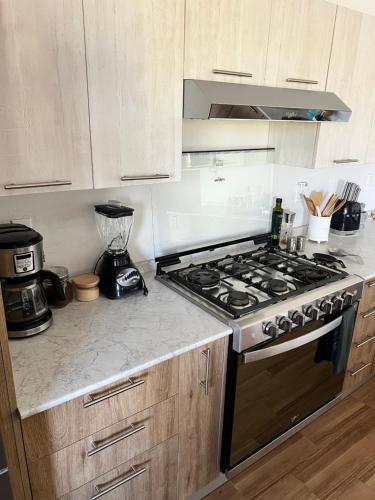 a kitchen with a stove and a counter top at La Ventana Apartments #6 in La Ventana