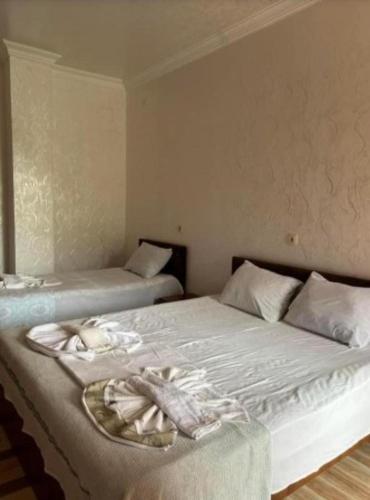 a bedroom with two beds with towels on them at Hotel Georgia in Gonio