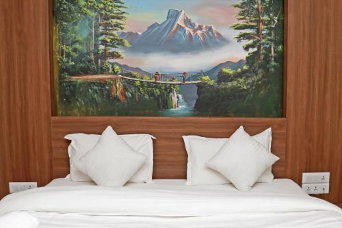 a bedroom with two beds with a painting on the wall at Hotel Dipjyoti in Kathmandu