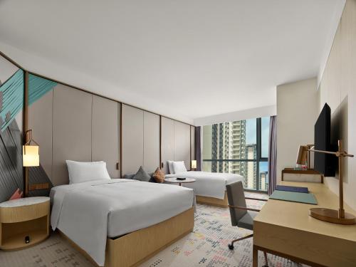 Postel nebo postele na pokoji v ubytování Doubletree By Hilton Nanning Wuxiang