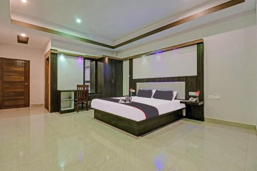 a bedroom with a large bed and a window at Collection O Sagayi International Resort in Hassan