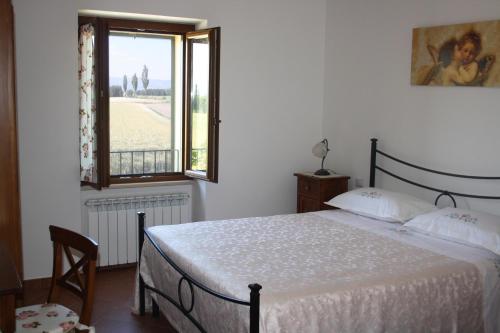 Кровать или кровати в номере Il Podere di Francesco