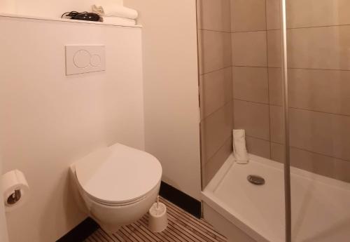 a white bathroom with a toilet and a shower at B&B HOTEL Nice Stade Riviera in Nice
