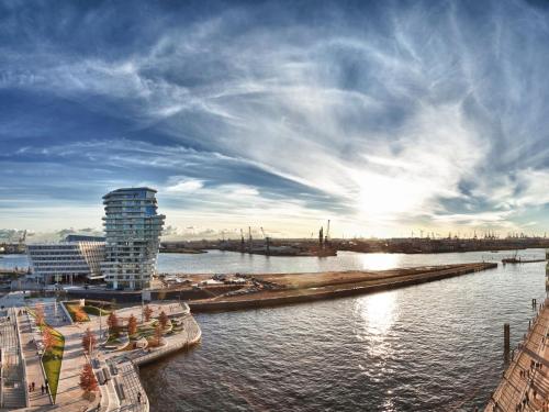 a view of a river with a building and a city at Novotel Hamburg Central Station in Hamburg