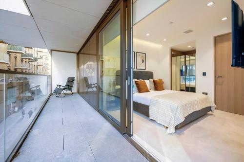 a bedroom with a bed and sliding glass doors at ARCORE Premium Apartments London Bridge in London