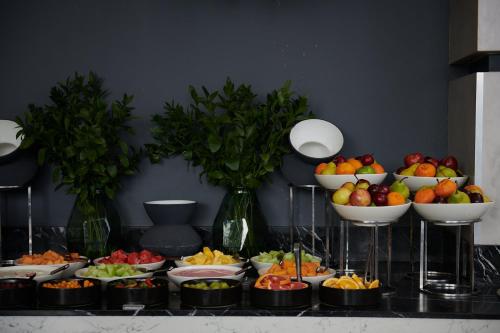 a bunch of bowls of fruit on a table at Seven Villa Hotel & Spa in Johannesburg