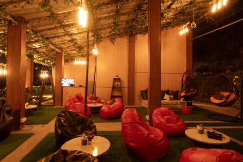 a room with red bean bags and tables in it at THE BUNK STREET in Manāli