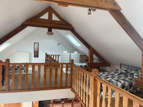 an attic room with a bed and a staircase at Logement 6 personnes avec SPA in Essômes-sur-Marne