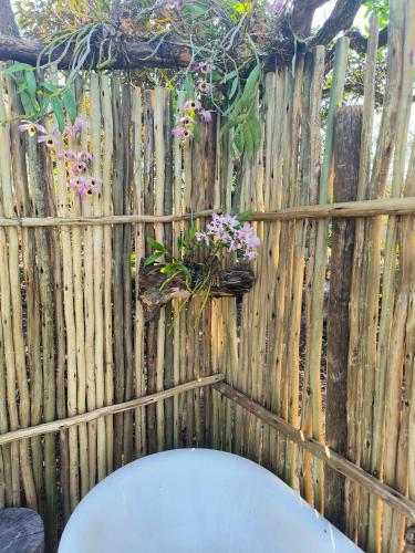 a wooden fence with a flower planter on it at Eloff Guest House and Gallery in White River