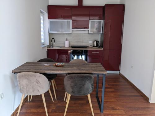 a small kitchen with a wooden table and chairs at kuća za odmor Dolno in Sisak