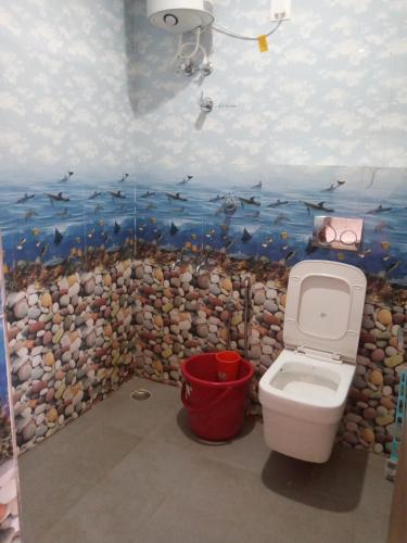 a bathroom with a fish mural on the wall at Sai Trishuul home stay in Ooty