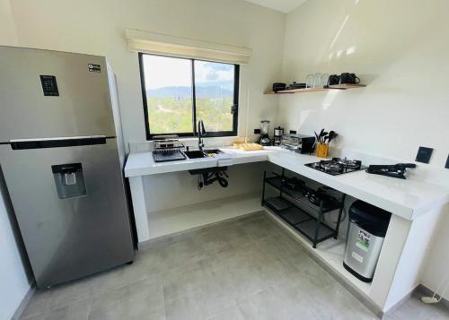 uma cozinha com um balcão branco e um frigorífico em La Ventana Apartments Torote #5 em La Ventana