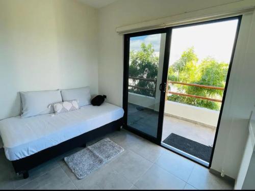 a room with a couch and a large glass door at La Ventana Apartments Torote #5 in La Ventana