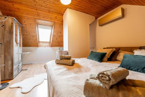 a bedroom with two beds in a room with wooden ceilings at Apartmán Mezonet na Námestí Košice in Košice