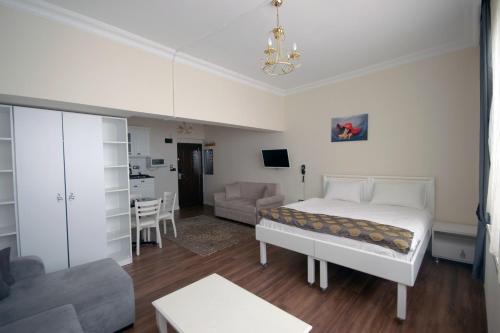 a bedroom with a bed and a living room at IQ Hotel Beyoğlu in Istanbul