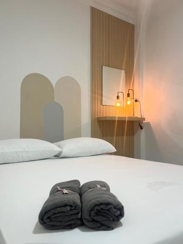 a bed with two towels sitting on top of it at Rainhill@Betong in Betong