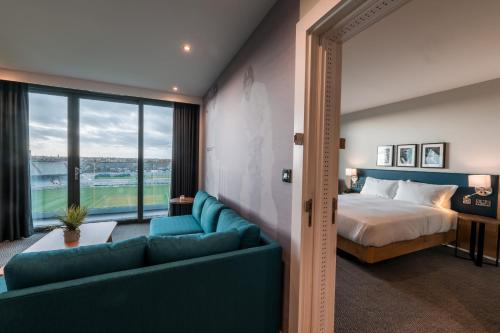 a hotel room with a bed and a couch at Hilton Garden Inn Manchester Emirates Old Trafford in Manchester