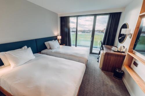 a hotel room with two beds and a window at Hilton Garden Inn Manchester Emirates Old Trafford in Manchester