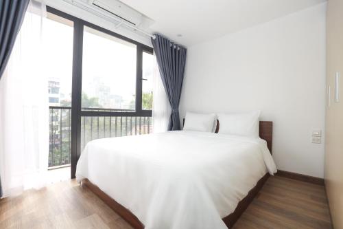 Postel nebo postele na pokoji v ubytování Wins Apartment