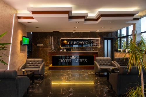 a hotel lobby with a reception desk and chairs at HOTEL ALBES in Prizren