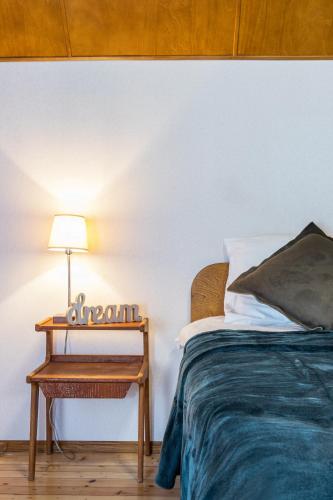 a bedroom with a bed and a table with a lamp at Kadriorg by Rikas Hotels in Tallinn