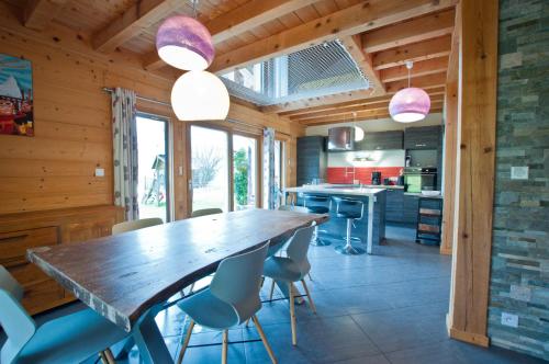 a kitchen with a large wooden table and chairs at Chalet La Merlerie in Morzine