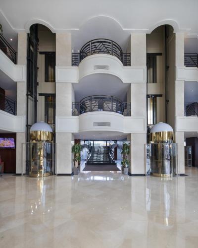 a large building with a lobby with two elevators at Grand Mogador City Center in Casablanca
