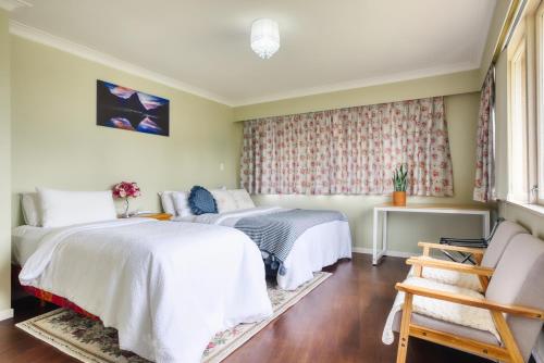 a bedroom with two beds and a window at Sweet Home between CBD and University in Hamilton