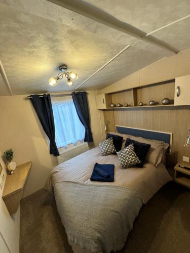 a bedroom with a large bed in a room at Bayview Bliss - Luxury Holiday Caravan - Northumberland in Newbiggin-by-the-Sea