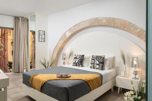 a bedroom with a large bed with an archway at Elia Portou Luxury Residence in Chania Town
