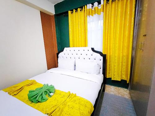 a bedroom with a bed and a window with yellow curtains at Cozy Haven Slumber in Nanyuki