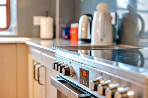 a close up of a stove in a kitchen at Finest Retreats - The Onibury in Onibury