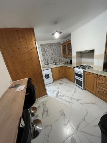 a kitchen with a marble floor and a stove at 2 Bedroom Refurbished House in Curdworth