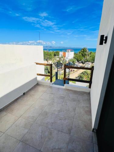 a balcony with a view of the ocean at La Ventana Apartments Carambullo #8 in La Ventana