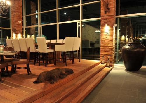 a dog laying on a wooden floor in a dining room at Avala Resort & Villas in Budva