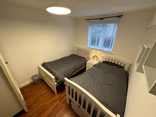 a bedroom with two beds and a window at 2 Bedrooms Luxurious Apartment in Luton in Luton