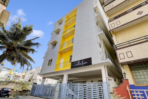 een gebouw met een gele en witte bij Collection O Relax Stay Apartments in Bangalore