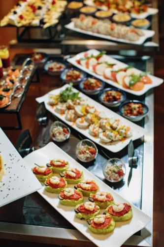 a buffet line with many different plates of food at Grand Mogador City Center in Casablanca