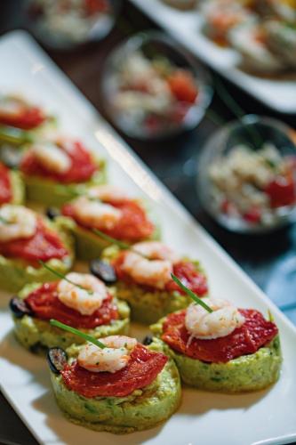 a plate of food with shrimp and cheese on it at Grand Mogador City Center in Casablanca