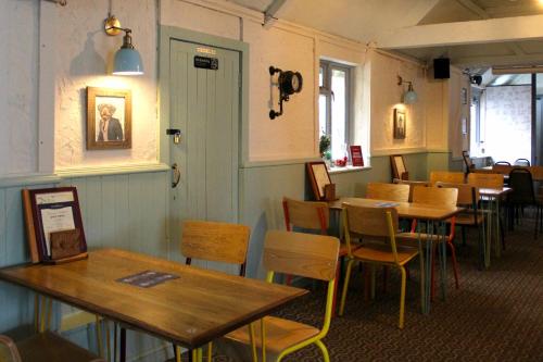 a dining room with tables and chairs in a restaurant at Dog and Partridge Inn in Calne