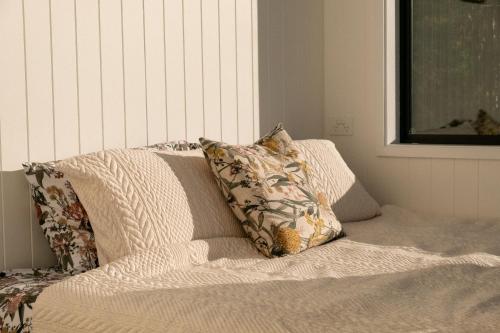 a pillow sitting on top of a bed at Wild Life Cabin 2 - Grampians in Halls Gap