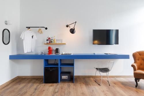 a blue desk in a kitchen with a chair at The Baroness in Kalamata