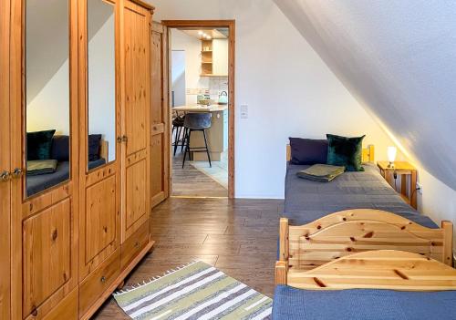 a bedroom with two beds and a staircase at FeWoMaurer WG1 Dachgeschoss in Altendorf
